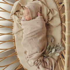 Bleu La La pointelle blanket on baby lap demonstrates gentle weight and wrap-friendly snugness