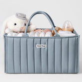 Blissful Diary diaper caddy in dusty blue on a changing table for easy access to newborn essentials.