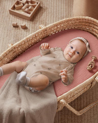 Blissful Diary muslin bassinet sheet elastic band secures a snug fit.