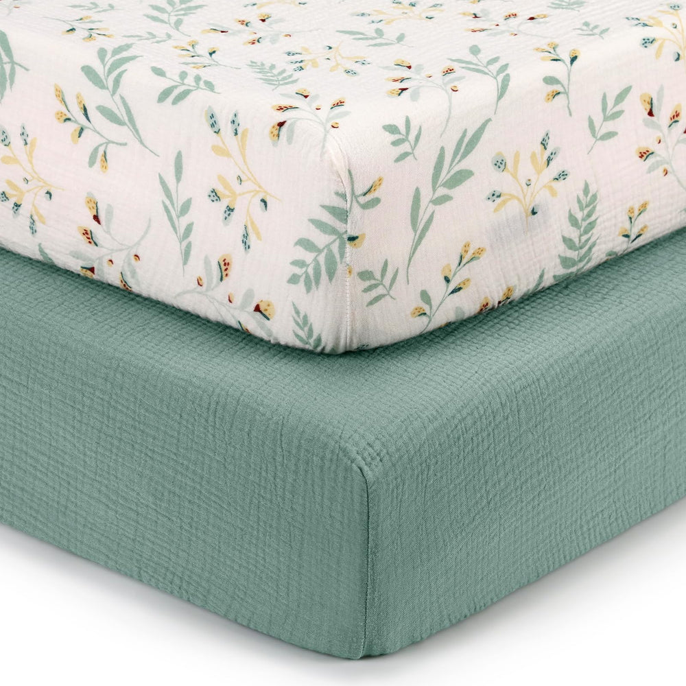 Blissful Diary muslin crib sheets in Roman Green Leaf offer breathable comfort for restful naps.