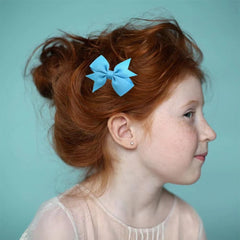 BOENBE LOVED green mini bows worn in toddler hair during playtime staying in place.