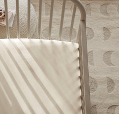 Boll & Branch Signature crib sheet organic cotton fibers highlight toxin-free materials for peaceful nights.