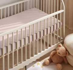 Boll & Branch Signature Hemmed Crib Sheet β close-up fabric shows breathable, toxin-free organic cotton texture.