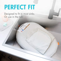 Boon Puff+ swaddle wings cradle baby for secure, comforting baths.