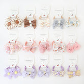 BOUNIQ baby hair ties with bows demonstrate durable elastic for secure toddler ponytails.
