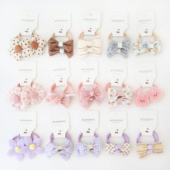 BOUNIQ baby hair ties with bows demonstrate durable elastic for secure toddler ponytails.