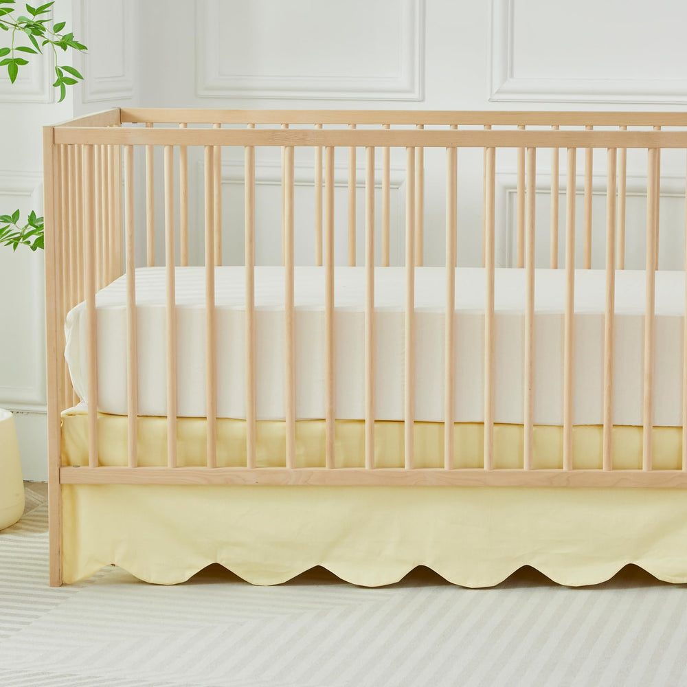 Brandream scallop edge crib skirt in light yellow adds soft, stylish nursery charm.