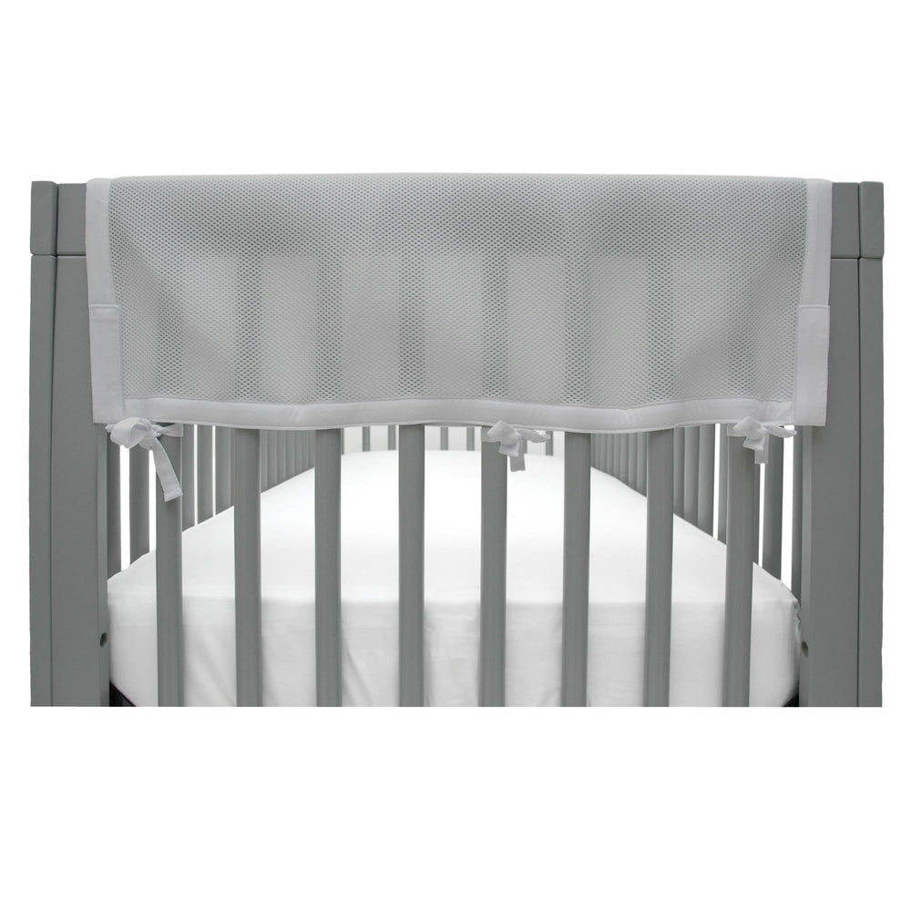 BreathableBaby RailGuard attached to crib rail in gray for teething protection