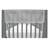 BreathableBaby RailGuard attached to crib rail in gray for teething protection