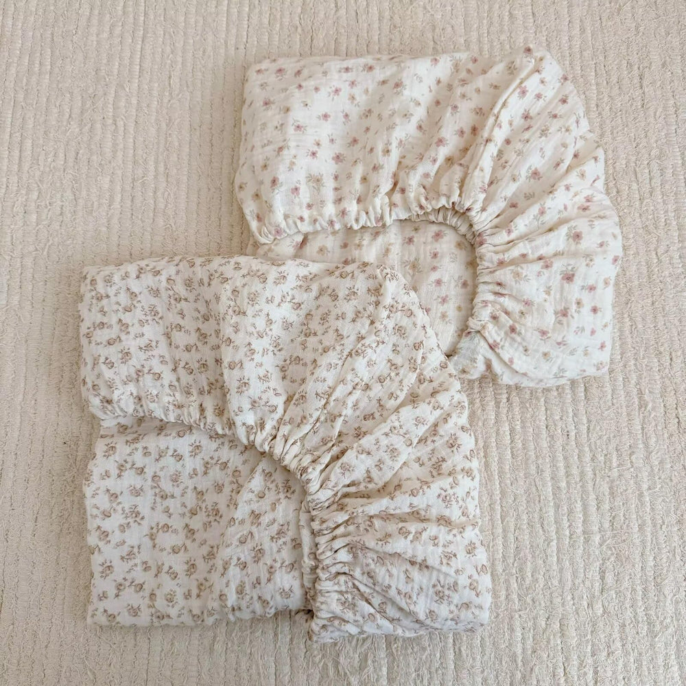 BuLuTu cotton muslin crib sheet close-up shows soft breathable fabric for baby comfort.