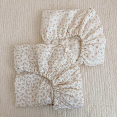 BuLuTu cotton muslin crib sheet close-up shows soft breathable fabric for baby comfort.