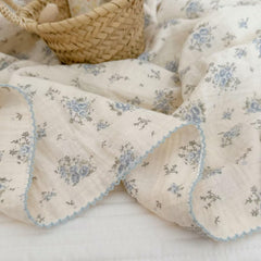 BuLuTu crib or toddler bed setup with blue florals for gentle nursery decor