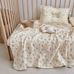 BuLuTu muslin blanket on crib, olive pattern, gentle skin-friendly comfort.
