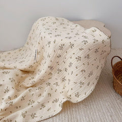BuLuTu muslin blanket in nursery, olive pattern, lightweight warmth for naps.