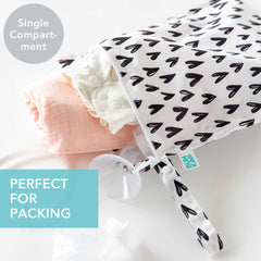 Bumkins waterproof wet bag arrows-hearts attached to stroller demonstrates quick-access storage