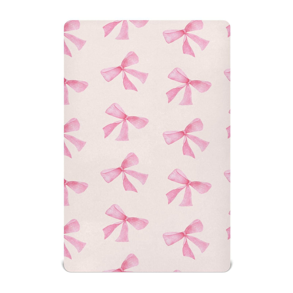 Burbuja Pink Bow crib sheet close-up shows soft modal fabric for gentle touch