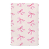 Burbuja Pink Bow crib sheet close-up shows soft modal fabric for gentle touch