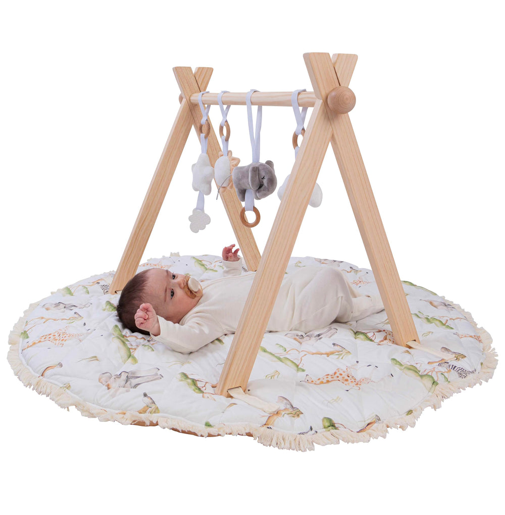 Butterfly + Bloom Montessori wooden baby play gym setup for sensory development