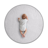 Byrd and Blume round baby play mat gray folded for travel with cushioned comfort.