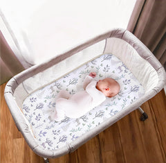 Cambria Baby forest fit shows secure elastic edge for multiple bassinet brands.