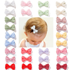 CellElection 2-inch mini bow clip on top view for baby hair, gentle hold.