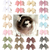 CellElection baby hair bow clips closeup demonstrates gentle hold for fine hair.