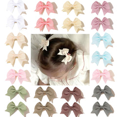 CellElection baby hair bow clips closeup demonstrates gentle hold for fine hair.