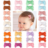 CellElection mini bow clip closeup highlights tiny size perfect for fine baby hair.
