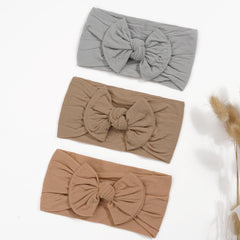 CÉLLOT elastic headbands fit newborns to toddlers all day.