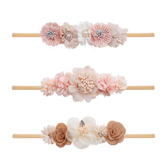 Cherrboll flower headband on newborn with soft nylon comfort for delicate skin.