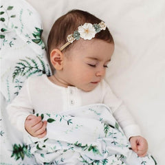 Cherrboll newborn headband shown on head demonstrates growth-friendly stretch