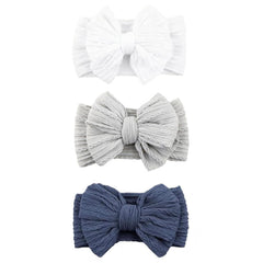 Chiduerm baby bows headband in white offers soft nylon comfort for delicate infant skin.