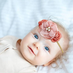 Cinaci flower headband pale mauve on a baby for a delicate photo look