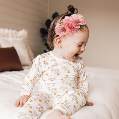 Cinaci headbands close-up reveals daisy flowers with rhinestones for dress-up moments.