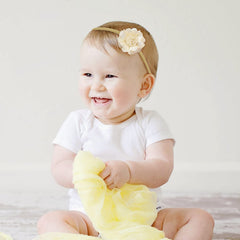 Cinaci handmade flowers on nude nylon bands—super stretchy and comfortable for newborns to toddlers