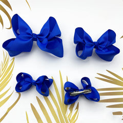 Clipband Blue Bows on child hair demonstrates durable clips for daily wear.