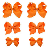 Clipband Orange Bows 6pcs pack ready to brighten outfits with secure clips.
