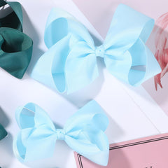 Clipband Sky Blue Bows closeup shows handmade grosgrain texture.