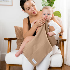 Comfy Cubs burp cloths in use with baby drool, soft daily essential.