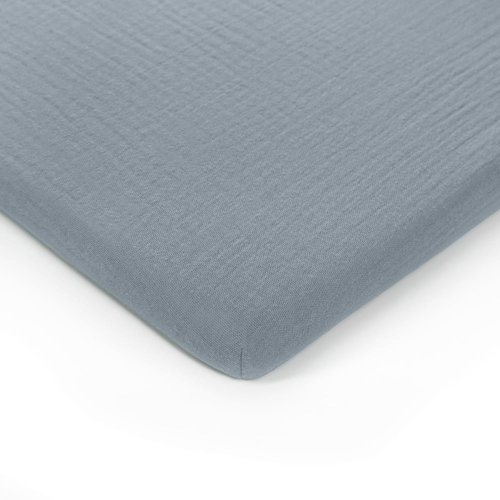 Comfy Cubs muslin bassinet sheet unfolded, breathable cotton for baby sleep comfort.