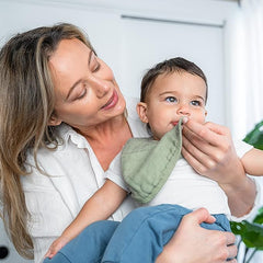 Comfy Cubs bibs sage on baby mealtime—absorbent layers catch spills during meals.