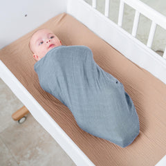 Comfy Cubs Pacific Blue swaddle wrap around baby promotes secure soothing.