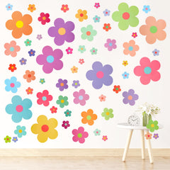 COMNICO 63pcs flower wall sticker set in assorted sizes for vibrant bedroom decor.