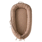 CooCooBaby infant lounger brown blossom cover in use offers cozy support during supervised play.