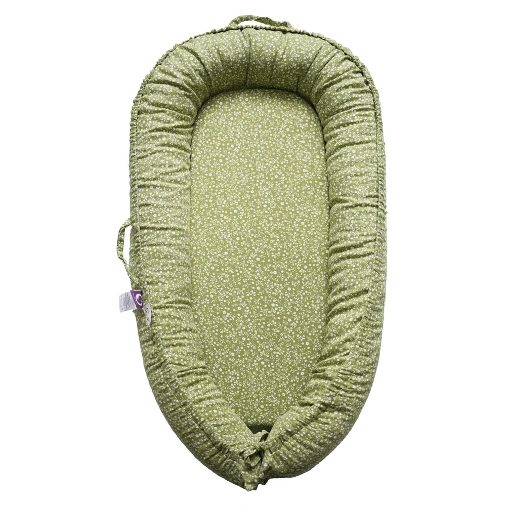 CooCooBaby infant lounger in Green Wonder cover offers cradle-like support during play.