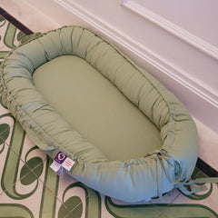 CooCooBaby infant lounger side view demonstrates adjustable ends for growing baby