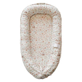 CooCooBaby infant lounger Wonderland Muslin close-up showcasing breathable cotton for gentle baby comfort.