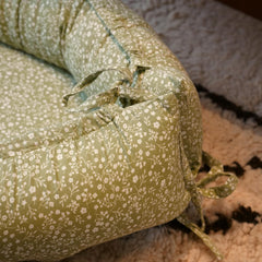 CooCooBaby nest cover double-sided design adapts as babies grow.