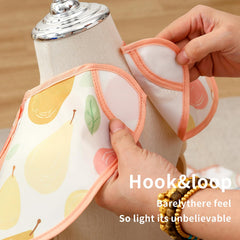 CoolaPeach bib with large pocket close-up demonstrates crumb catching and snack storage