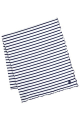 Coolibar Sun Blanket laid on park grass, ideal for picnics with UPF 50+ sun protection.